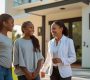 Modern supported accommodation home warm and welcoming friendly professional adult speaking with two diverse teenagers outside the entrance sunny day realistic photography style2 90x80